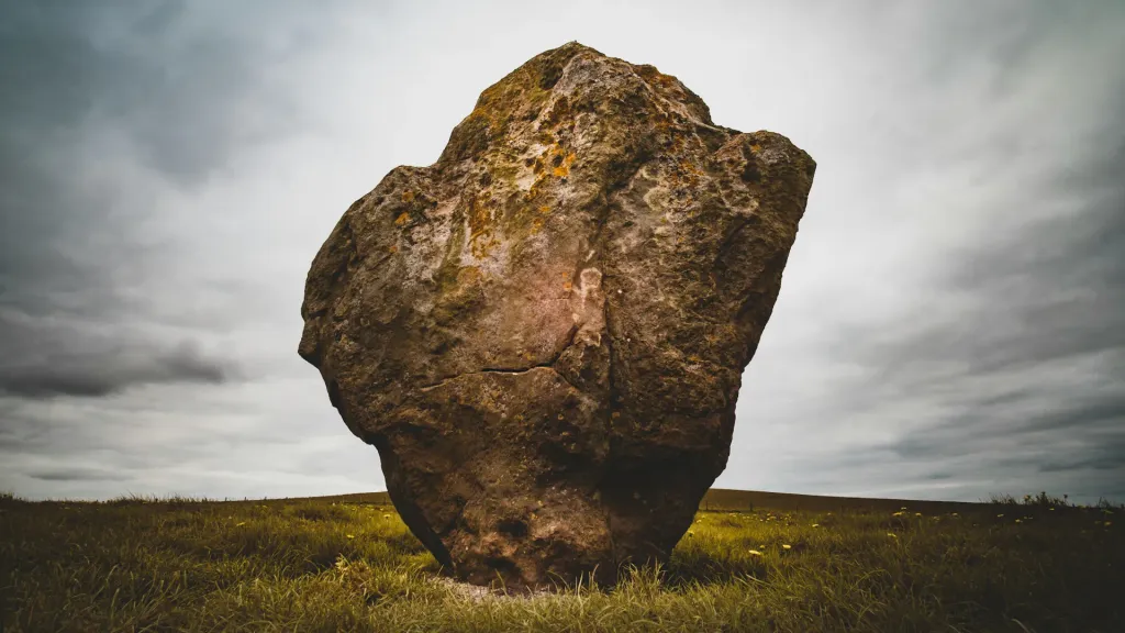 Brown rock formation surrounded by green grass